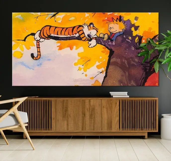 The Cartoon Wall Art Calvin and Hobbes Canvas Print features a boy and a tiger lounging on a tree branch amidst vibrant autumn leaves. Crafted on museum-quality canvases with UV-protective coating, this artwork elevates any room.