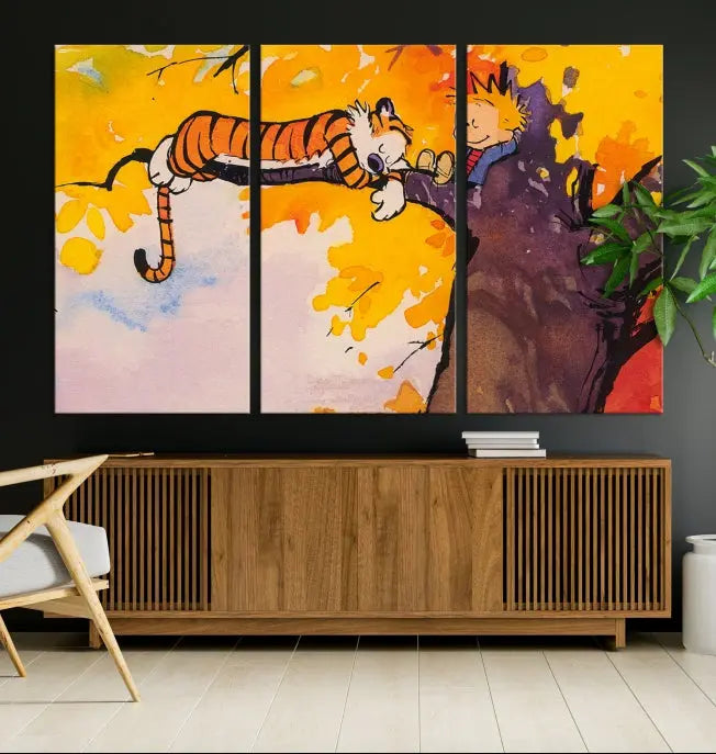 The Cartoon Wall Art Calvin and Hobbes Canvas Print features a boy and a tiger lounging on a tree branch amidst vibrant autumn leaves. Crafted on museum-quality canvases with UV-protective coating, this artwork elevates any room.