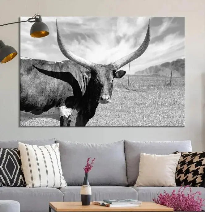 A black and white image of a longhorn cow, expertly divided into three panels, is printed on high-quality poly-cotton canvas. This Cattle Wall Art Longhorn Cow Canvas Print is professionally hand-assembled. Enjoy the ease of free shipping included with your purchase for ultimate convenience.