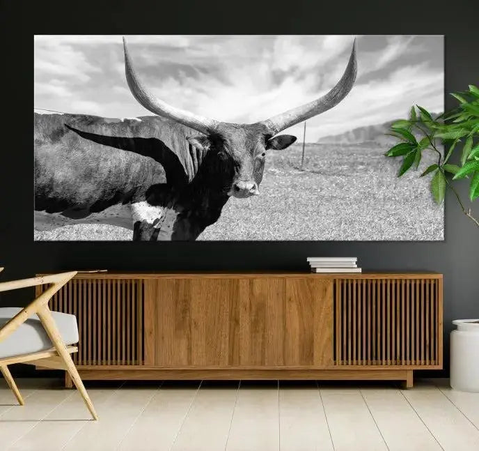 A black and white image of a longhorn cow, expertly divided into three panels, is printed on high-quality poly-cotton canvas. This Cattle Wall Art Longhorn Cow Canvas Print is professionally hand-assembled. Enjoy the ease of free shipping included with your purchase for ultimate convenience.