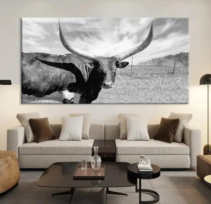 A black and white image of a longhorn cow, expertly divided into three panels, is printed on high-quality poly-cotton canvas. This Cattle Wall Art Longhorn Cow Canvas Print is professionally hand-assembled. Enjoy the ease of free shipping included with your purchase for ultimate convenience.