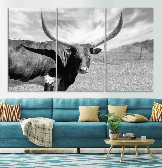 A black and white image of a longhorn cow, expertly divided into three panels, is printed on high-quality poly-cotton canvas. This Cattle Wall Art Longhorn Cow Canvas Print is professionally hand-assembled. Enjoy the ease of free shipping included with your purchase for ultimate convenience.