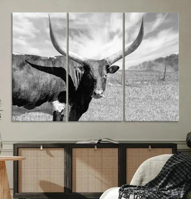 A black and white image of a longhorn cow, expertly divided into three panels, is printed on high-quality poly-cotton canvas. This Cattle Wall Art Longhorn Cow Canvas Print is professionally hand-assembled. Enjoy the ease of free shipping included with your purchase for ultimate convenience.