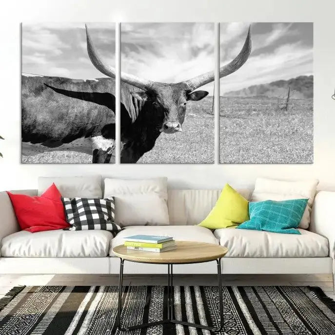 A black and white image of a longhorn cow, expertly divided into three panels, is printed on high-quality poly-cotton canvas. This Cattle Wall Art Longhorn Cow Canvas Print is professionally hand-assembled. Enjoy the ease of free shipping included with your purchase for ultimate convenience.