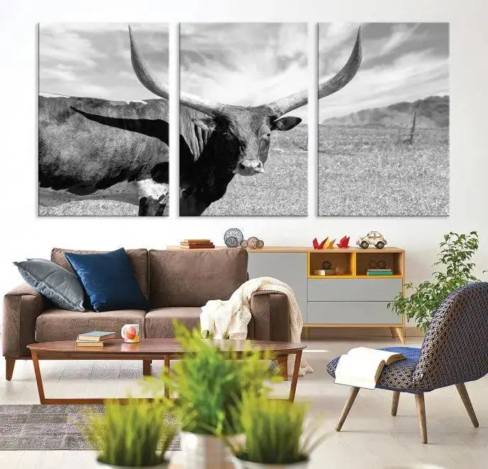 A black and white image of a longhorn cow, expertly divided into three panels, is printed on high-quality poly-cotton canvas. This Cattle Wall Art Longhorn Cow Canvas Print is professionally hand-assembled. Enjoy the ease of free shipping included with your purchase for ultimate convenience.