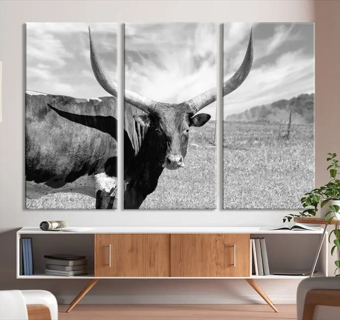 A black and white image of a longhorn cow, expertly divided into three panels, is printed on high-quality poly-cotton canvas. This Cattle Wall Art Longhorn Cow Canvas Print is professionally hand-assembled. Enjoy the ease of free shipping included with your purchase for ultimate convenience.