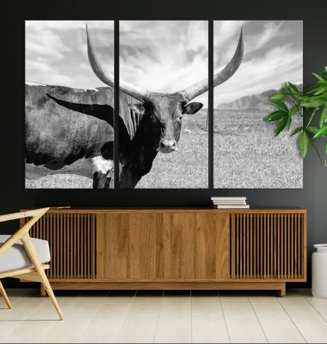 A black and white image of a longhorn cow, expertly divided into three panels, is printed on high-quality poly-cotton canvas. This Cattle Wall Art Longhorn Cow Canvas Print is professionally hand-assembled. Enjoy the ease of free shipping included with your purchase for ultimate convenience.