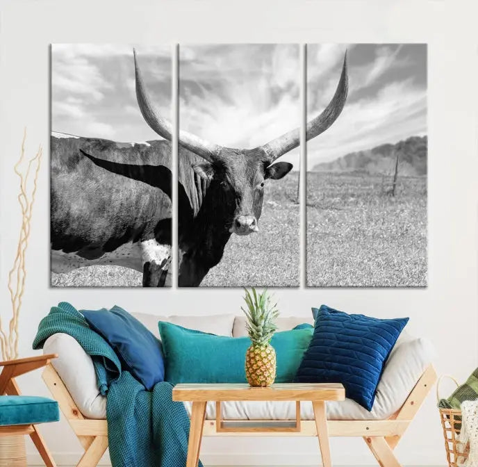 A black and white image of a longhorn cow, expertly divided into three panels, is printed on high-quality poly-cotton canvas. This Cattle Wall Art Longhorn Cow Canvas Print is professionally hand-assembled. Enjoy the ease of free shipping included with your purchase for ultimate convenience.