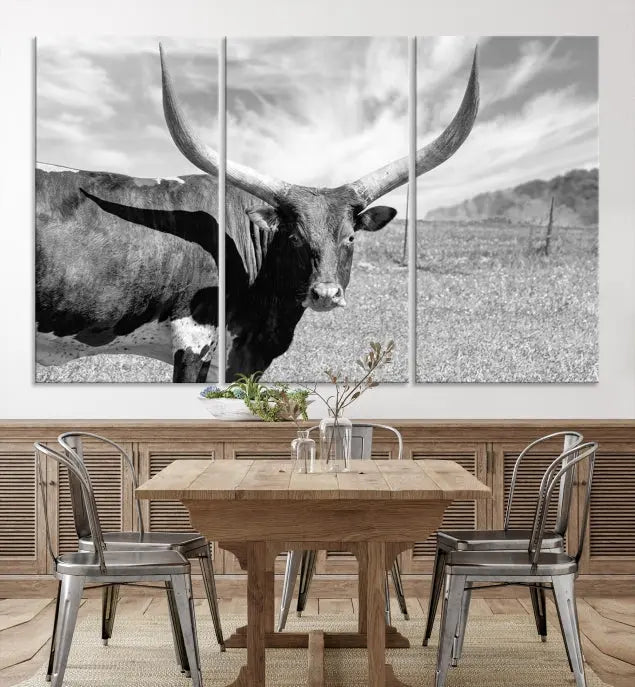 A black and white image of a longhorn cow, expertly divided into three panels, is printed on high-quality poly-cotton canvas. This Cattle Wall Art Longhorn Cow Canvas Print is professionally hand-assembled. Enjoy the ease of free shipping included with your purchase for ultimate convenience.