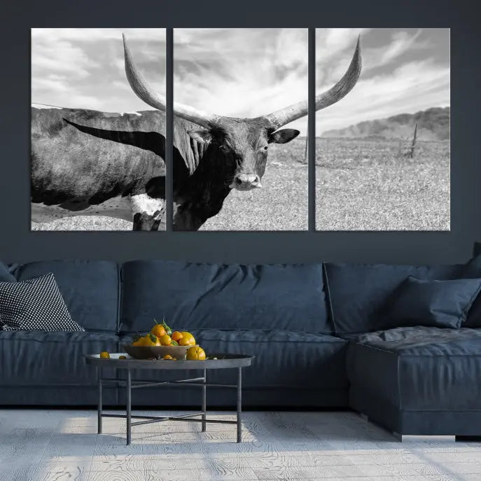 A black and white image of a longhorn cow, expertly divided into three panels, is printed on high-quality poly-cotton canvas. This Cattle Wall Art Longhorn Cow Canvas Print is professionally hand-assembled. Enjoy the ease of free shipping included with your purchase for ultimate convenience.