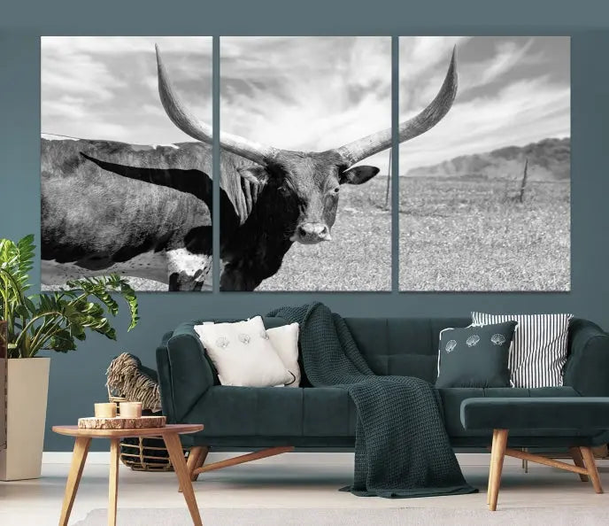 A black and white image of a longhorn cow, expertly divided into three panels, is printed on high-quality poly-cotton canvas. This Cattle Wall Art Longhorn Cow Canvas Print is professionally hand-assembled. Enjoy the ease of free shipping included with your purchase for ultimate convenience.