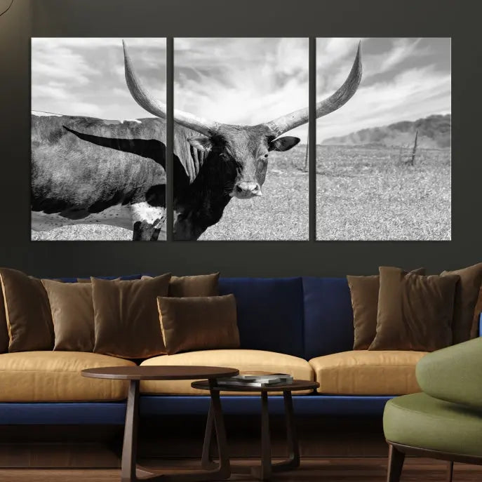 A black and white image of a longhorn cow, expertly divided into three panels, is printed on high-quality poly-cotton canvas. This Cattle Wall Art Longhorn Cow Canvas Print is professionally hand-assembled. Enjoy the ease of free shipping included with your purchase for ultimate convenience.