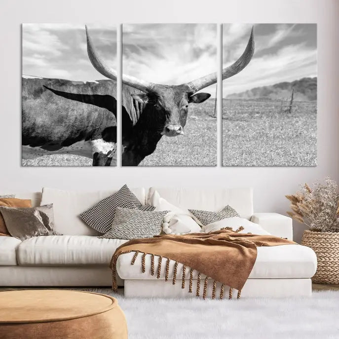 A black and white image of a longhorn cow, expertly divided into three panels, is printed on high-quality poly-cotton canvas. This Cattle Wall Art Longhorn Cow Canvas Print is professionally hand-assembled. Enjoy the ease of free shipping included with your purchase for ultimate convenience.