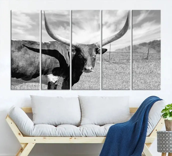 A black and white image of a longhorn cow, expertly divided into three panels, is printed on high-quality poly-cotton canvas. This Cattle Wall Art Longhorn Cow Canvas Print is professionally hand-assembled. Enjoy the ease of free shipping included with your purchase for ultimate convenience.