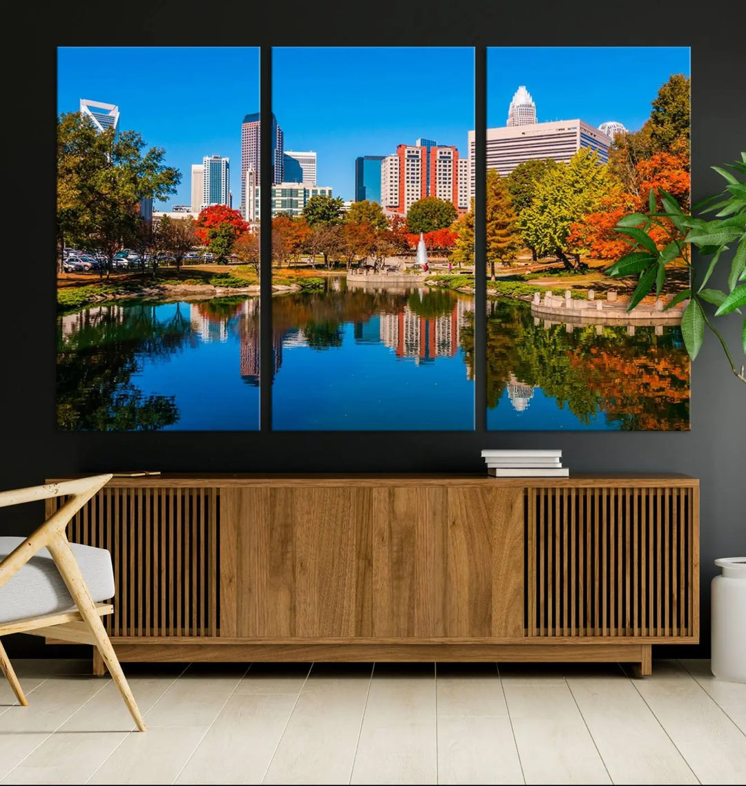 The "Charlotte City Autumn Morning Blue Skyline Cityscape View Wall Art Canvas Print" showcases a cityscape with vibrant autumn trees reflected in a lake. Its gallery-wrapped edges add depth to the scene, while the UV-protective coating ensures lasting brilliance.