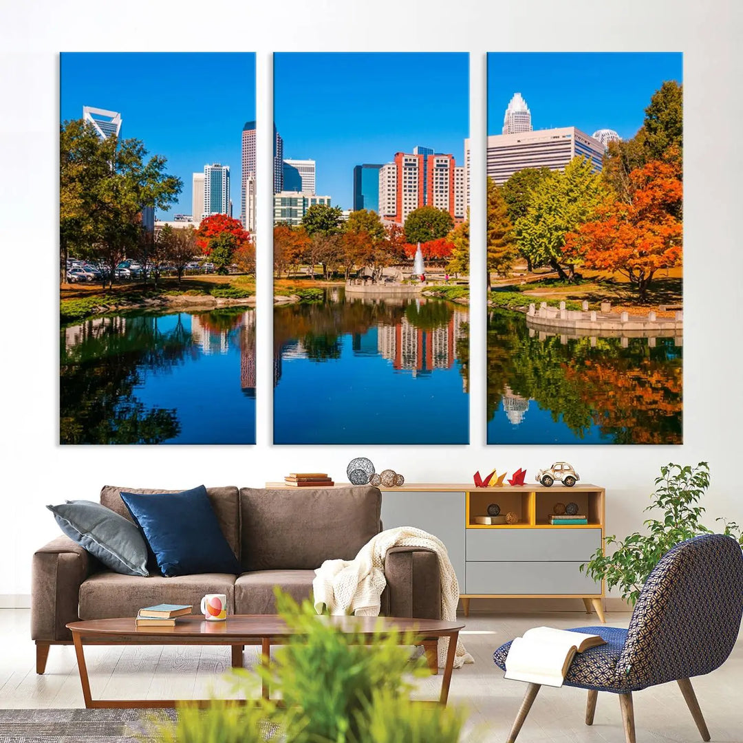 The "Charlotte City Autumn Morning Blue Skyline Cityscape View Wall Art Canvas Print" showcases a cityscape with vibrant autumn trees reflected in a lake. Its gallery-wrapped edges add depth to the scene, while the UV-protective coating ensures lasting brilliance.