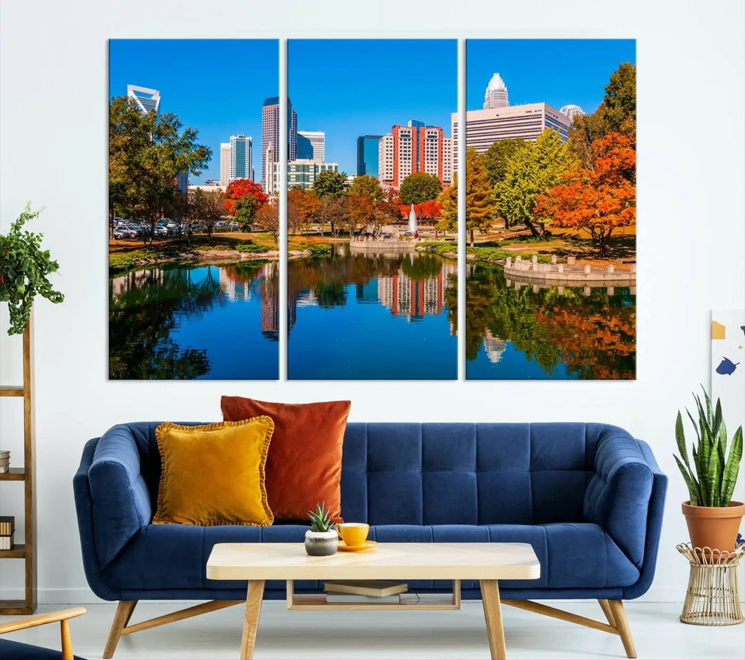 The "Charlotte City Autumn Morning Blue Skyline Cityscape View Wall Art Canvas Print" showcases a cityscape with vibrant autumn trees reflected in a lake. Its gallery-wrapped edges add depth to the scene, while the UV-protective coating ensures lasting brilliance.