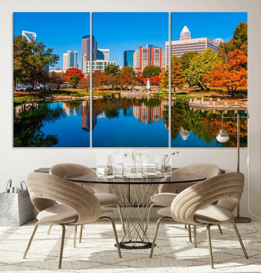 The "Charlotte City Autumn Morning Blue Skyline Cityscape View Wall Art Canvas Print" showcases a cityscape with vibrant autumn trees reflected in a lake. Its gallery-wrapped edges add depth to the scene, while the UV-protective coating ensures lasting brilliance.