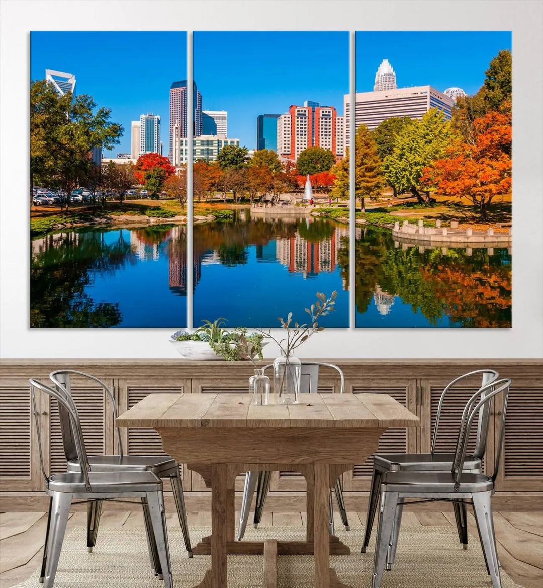 The "Charlotte City Autumn Morning Blue Skyline Cityscape View Wall Art Canvas Print" showcases a cityscape with vibrant autumn trees reflected in a lake. Its gallery-wrapped edges add depth to the scene, while the UV-protective coating ensures lasting brilliance.