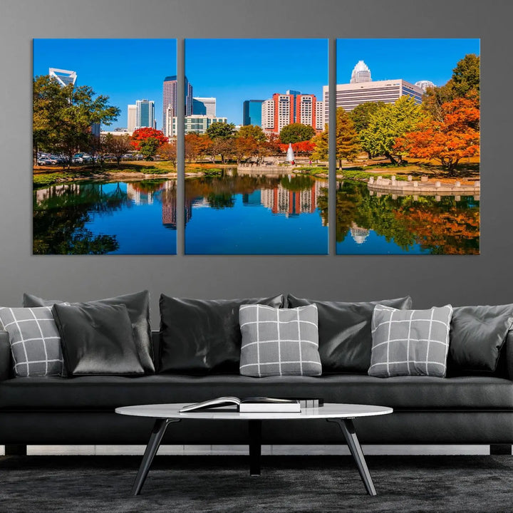 The "Charlotte City Autumn Morning Blue Skyline Cityscape View Wall Art Canvas Print" showcases a cityscape with vibrant autumn trees reflected in a lake. Its gallery-wrapped edges add depth to the scene, while the UV-protective coating ensures lasting brilliance.