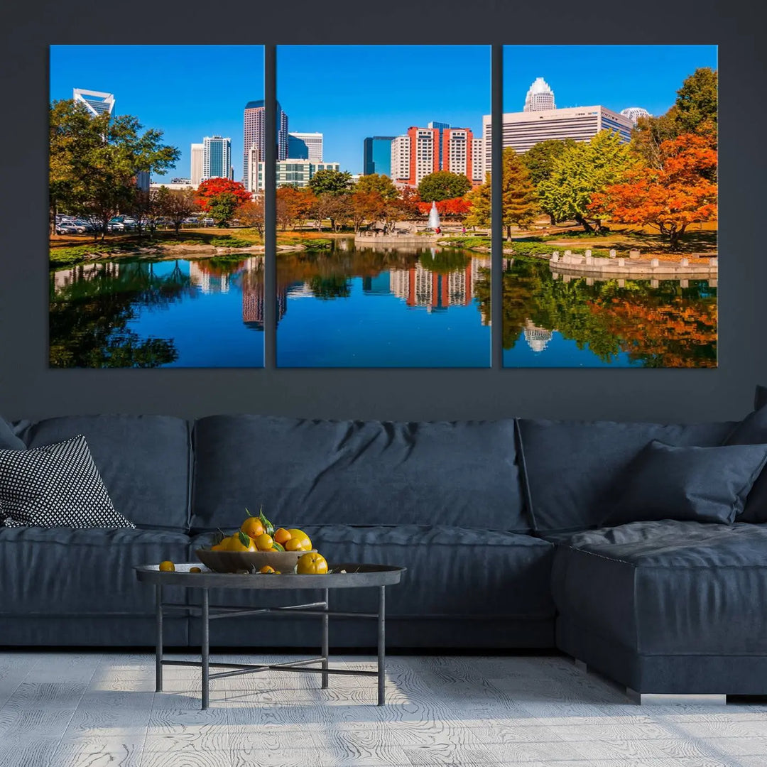 The "Charlotte City Autumn Morning Blue Skyline Cityscape View Wall Art Canvas Print" showcases a cityscape with vibrant autumn trees reflected in a lake. Its gallery-wrapped edges add depth to the scene, while the UV-protective coating ensures lasting brilliance.