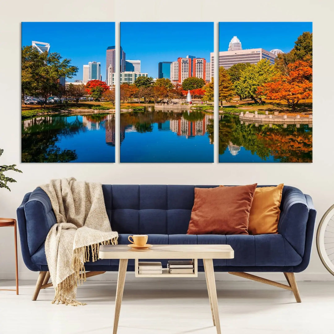 The "Charlotte City Autumn Morning Blue Skyline Cityscape View Wall Art Canvas Print" showcases a cityscape with vibrant autumn trees reflected in a lake. Its gallery-wrapped edges add depth to the scene, while the UV-protective coating ensures lasting brilliance.