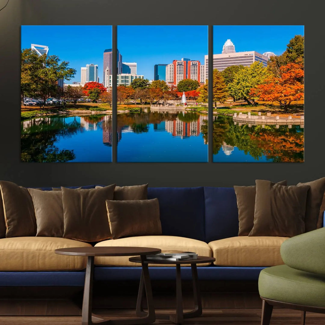 The "Charlotte City Autumn Morning Blue Skyline Cityscape View Wall Art Canvas Print" showcases a cityscape with vibrant autumn trees reflected in a lake. Its gallery-wrapped edges add depth to the scene, while the UV-protective coating ensures lasting brilliance.