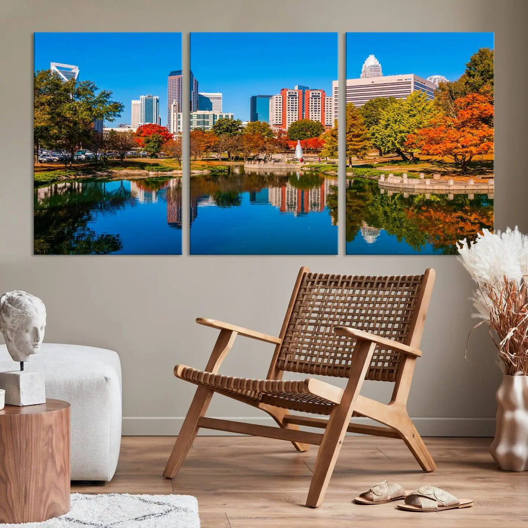 The "Charlotte City Autumn Morning Blue Skyline Cityscape View Wall Art Canvas Print" showcases a cityscape with vibrant autumn trees reflected in a lake. Its gallery-wrapped edges add depth to the scene, while the UV-protective coating ensures lasting brilliance.