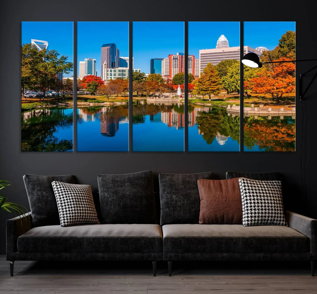 The "Charlotte City Autumn Morning Blue Skyline Cityscape View Wall Art Canvas Print" showcases a cityscape with vibrant autumn trees reflected in a lake. Its gallery-wrapped edges add depth to the scene, while the UV-protective coating ensures lasting brilliance.