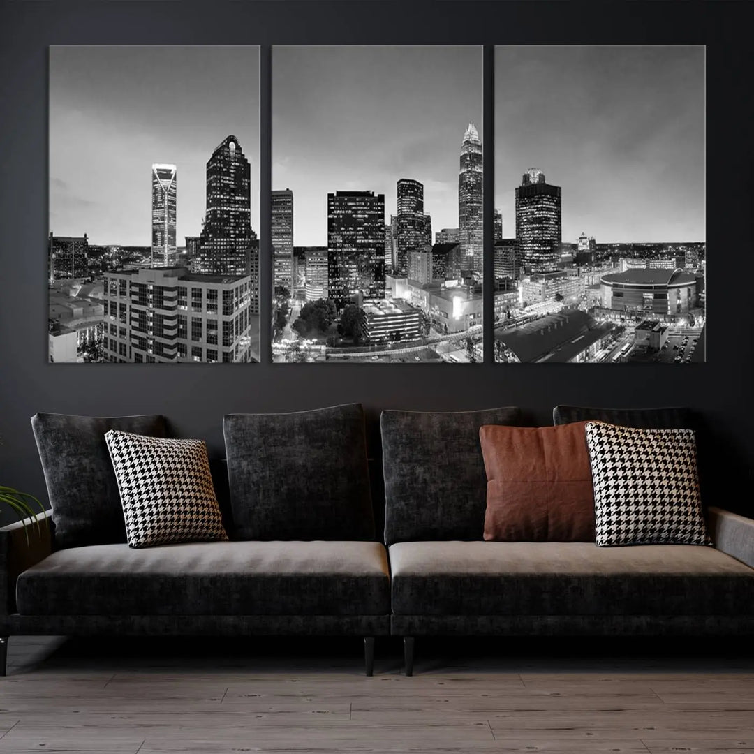 The "Charlotte City Cloudy Skyline Black and White Wall Art Cityscape Canvas Print" hangs on a dark wall, showcasing its UV-protective properties for enduring beauty.