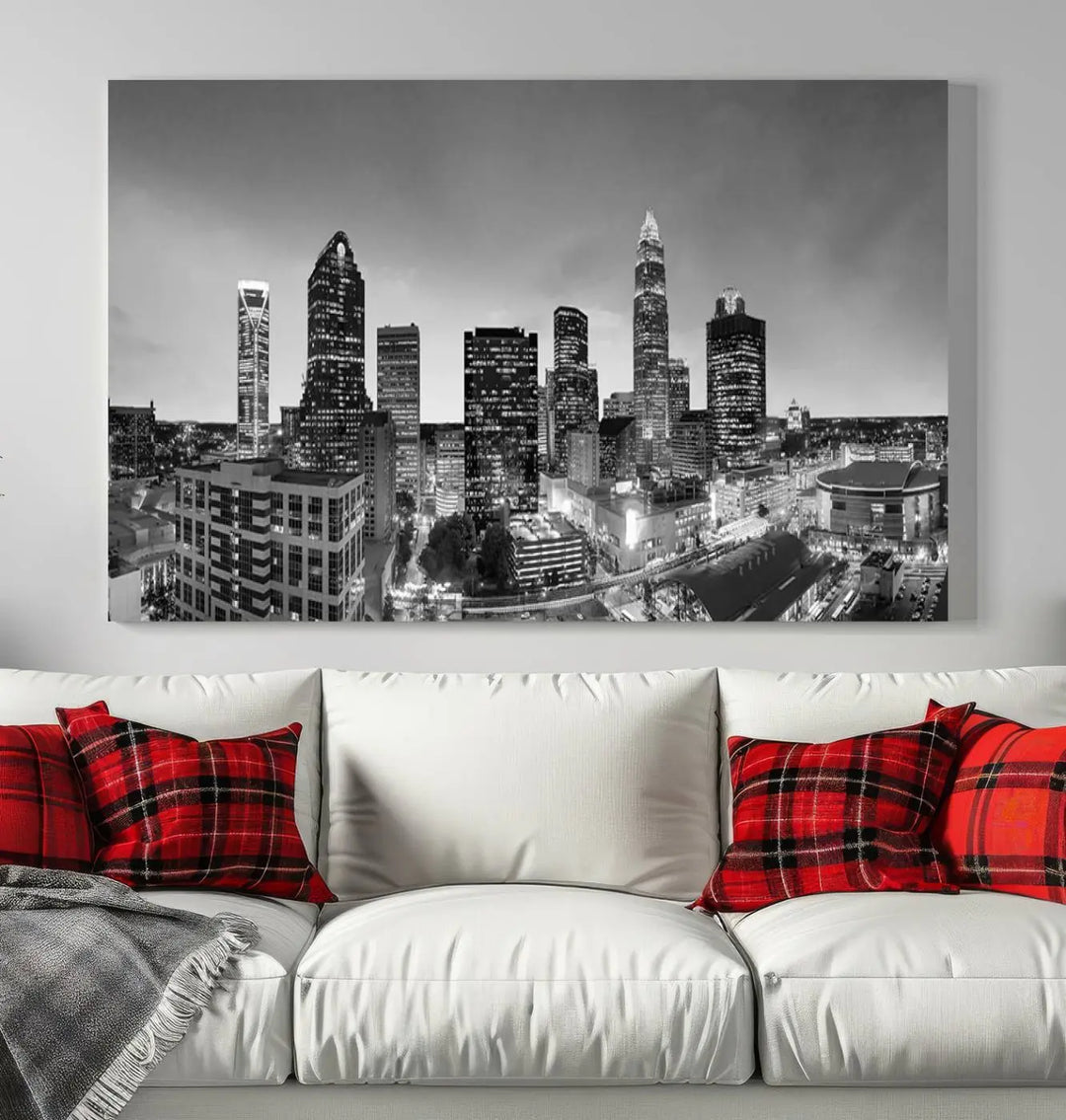 The "Charlotte City Cloudy Skyline Black and White Wall Art Cityscape Canvas Print" hangs on a dark wall, showcasing its UV-protective properties for enduring beauty.