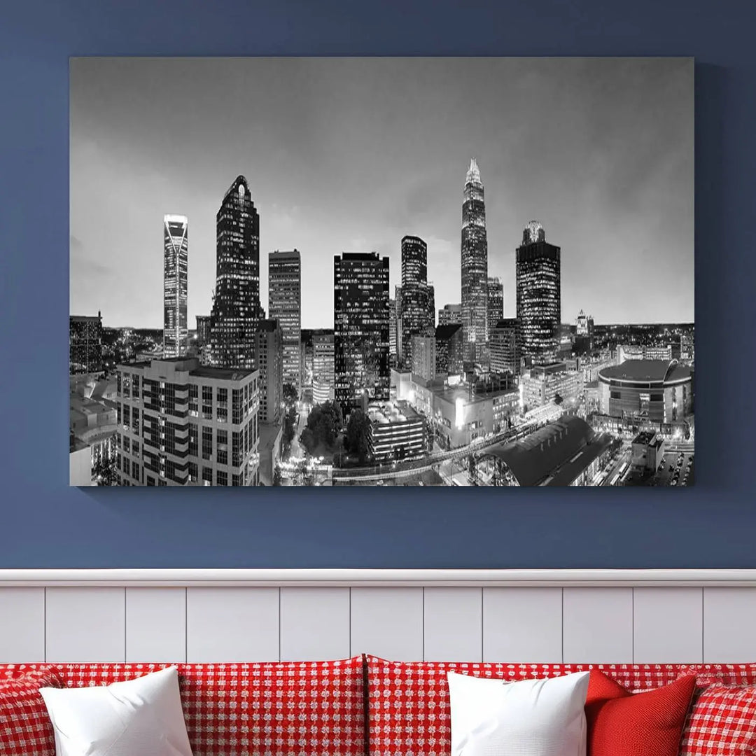 The "Charlotte City Cloudy Skyline Black and White Wall Art Cityscape Canvas Print" hangs on a dark wall, showcasing its UV-protective properties for enduring beauty.