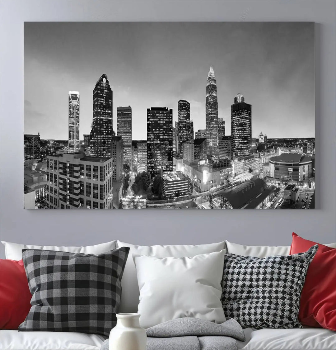 The "Charlotte City Cloudy Skyline Black and White Wall Art Cityscape Canvas Print" hangs on a dark wall, showcasing its UV-protective properties for enduring beauty.