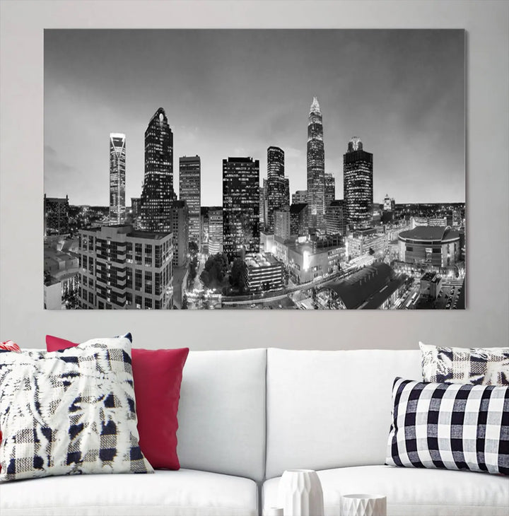 The "Charlotte City Cloudy Skyline Black and White Wall Art Cityscape Canvas Print" hangs on a dark wall, showcasing its UV-protective properties for enduring beauty.