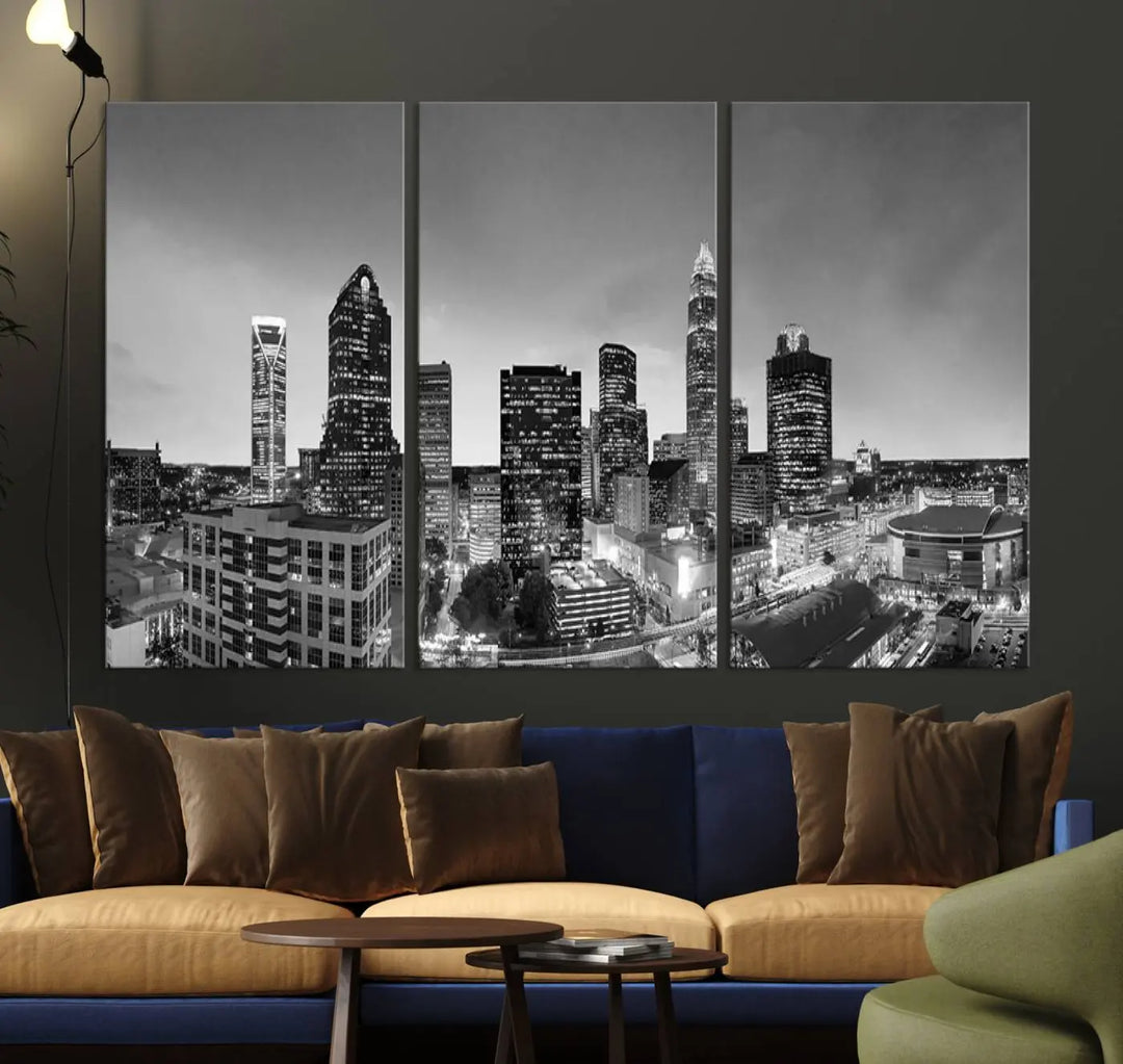 The "Charlotte City Cloudy Skyline Black and White Wall Art Cityscape Canvas Print" hangs on a dark wall, showcasing its UV-protective properties for enduring beauty.