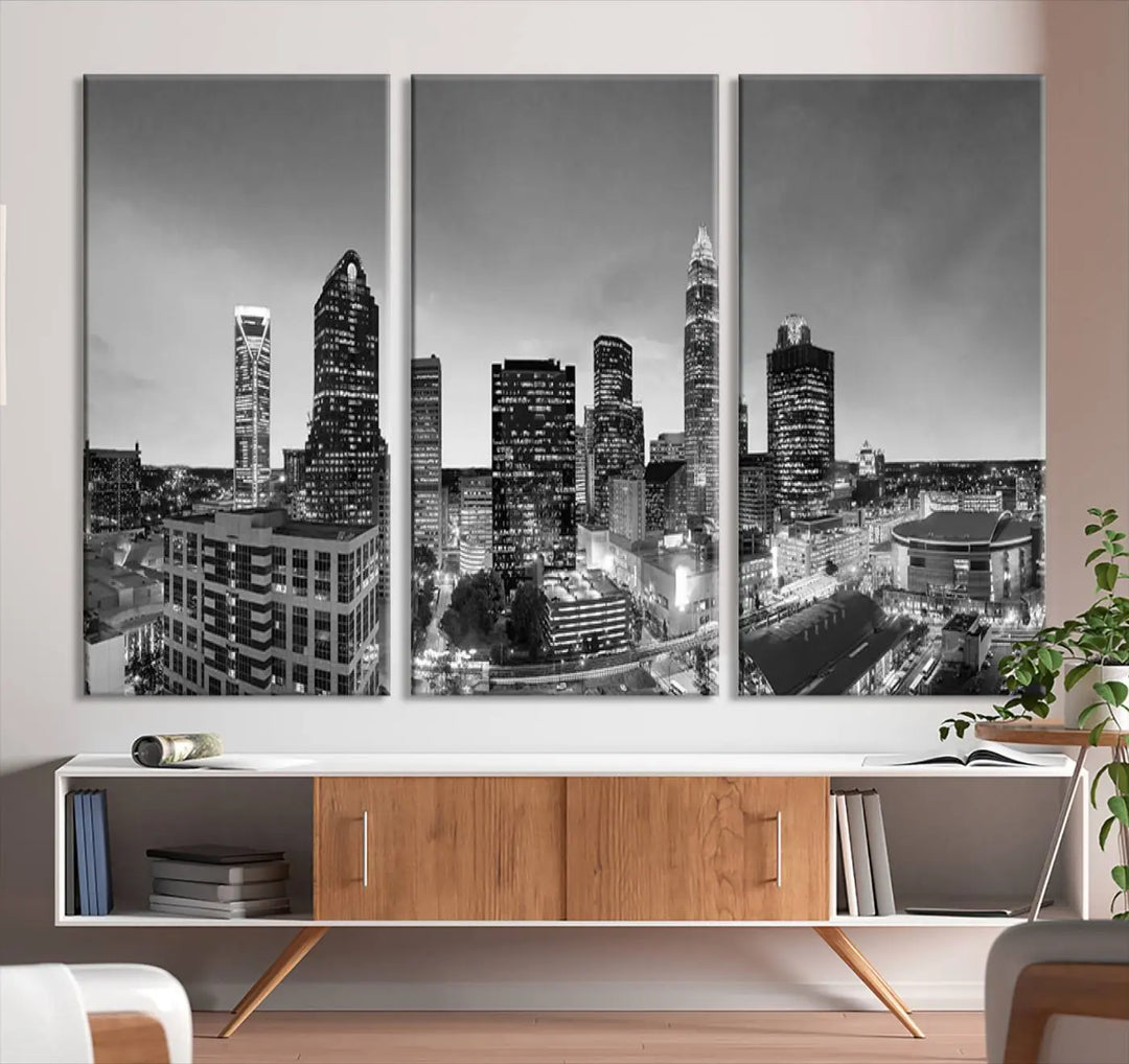 The "Charlotte City Cloudy Skyline Black and White Wall Art Cityscape Canvas Print" hangs on a dark wall, showcasing its UV-protective properties for enduring beauty.