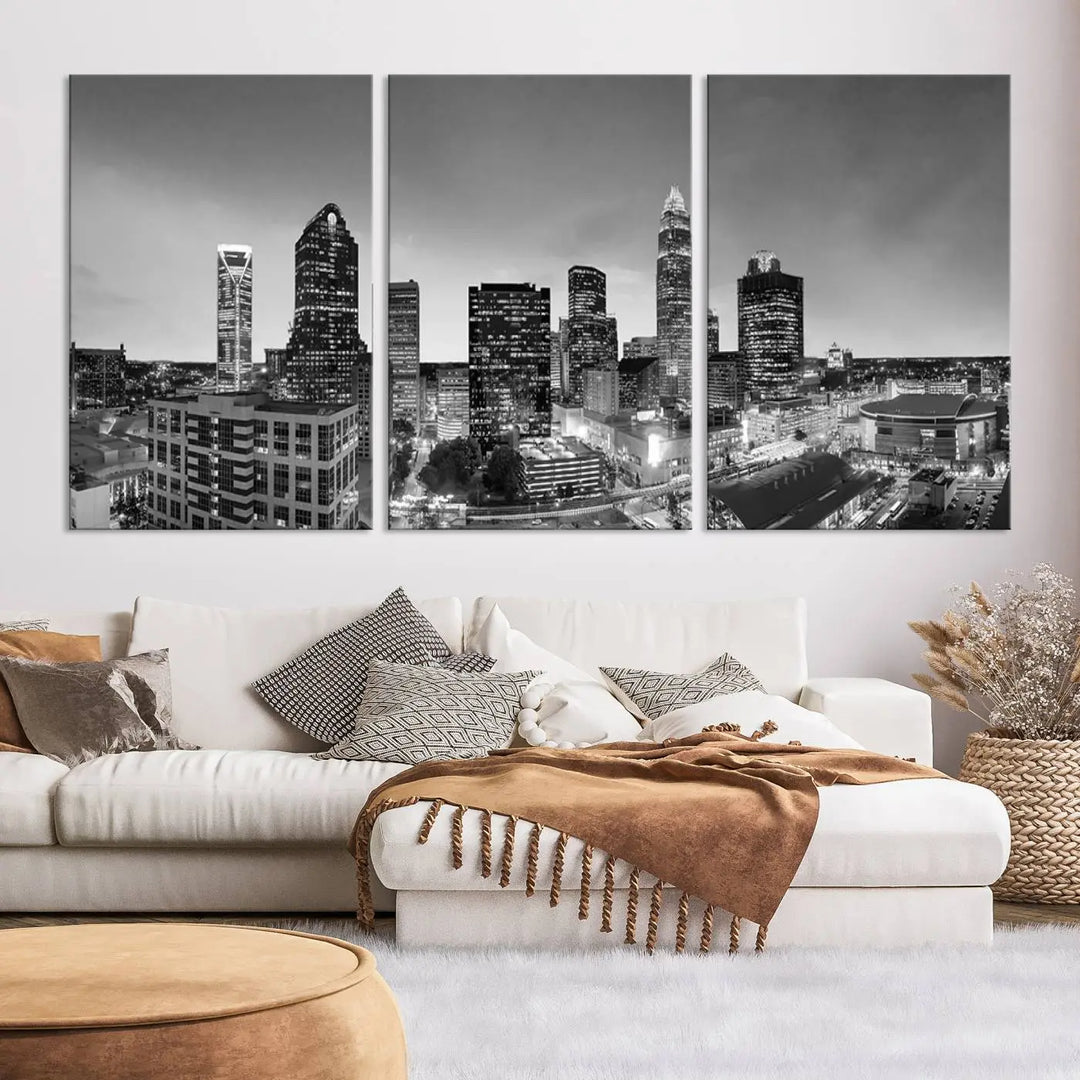 The "Charlotte City Cloudy Skyline Black and White Wall Art Cityscape Canvas Print" hangs on a dark wall, showcasing its UV-protective properties for enduring beauty.