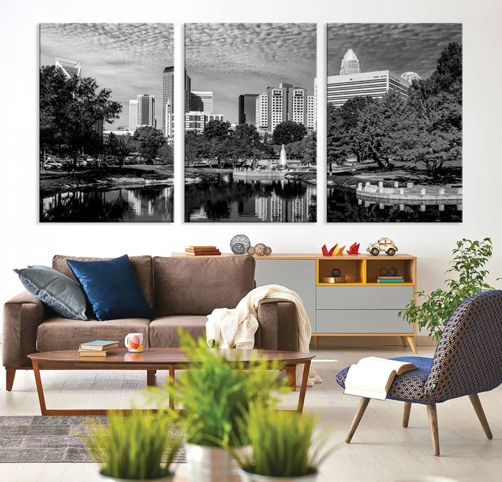 The living room features a captivating triptych titled "Charlotte City Cloudy Skyline Black and White Wall Art Cityscape Canvas Print," crafted on museum-quality canvas with UV-protective coating. Modern decor accentuates the dynamic scene.