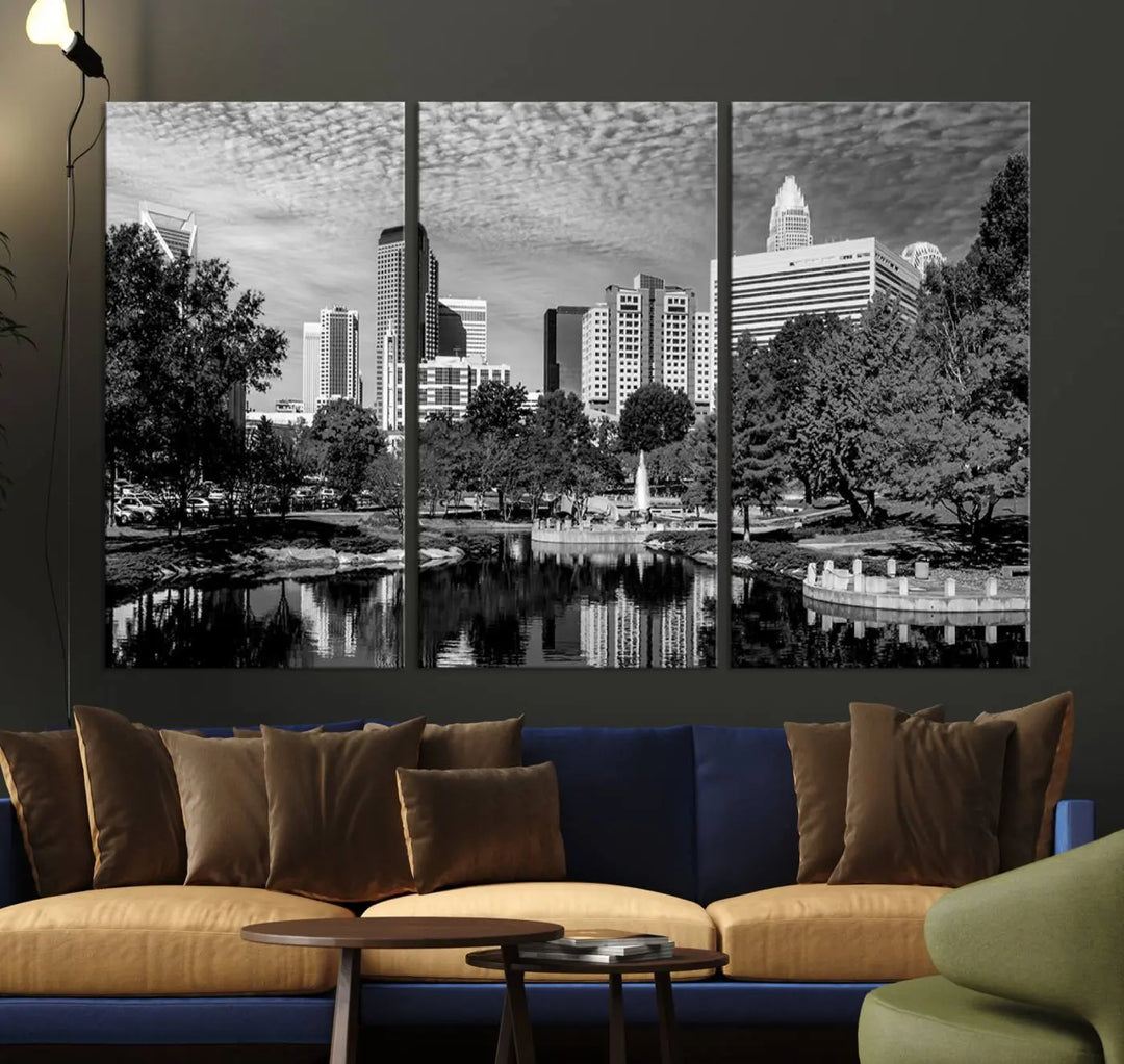 The living room features a captivating triptych titled "Charlotte City Cloudy Skyline Black and White Wall Art Cityscape Canvas Print," crafted on museum-quality canvas with UV-protective coating. Modern decor accentuates the dynamic scene.