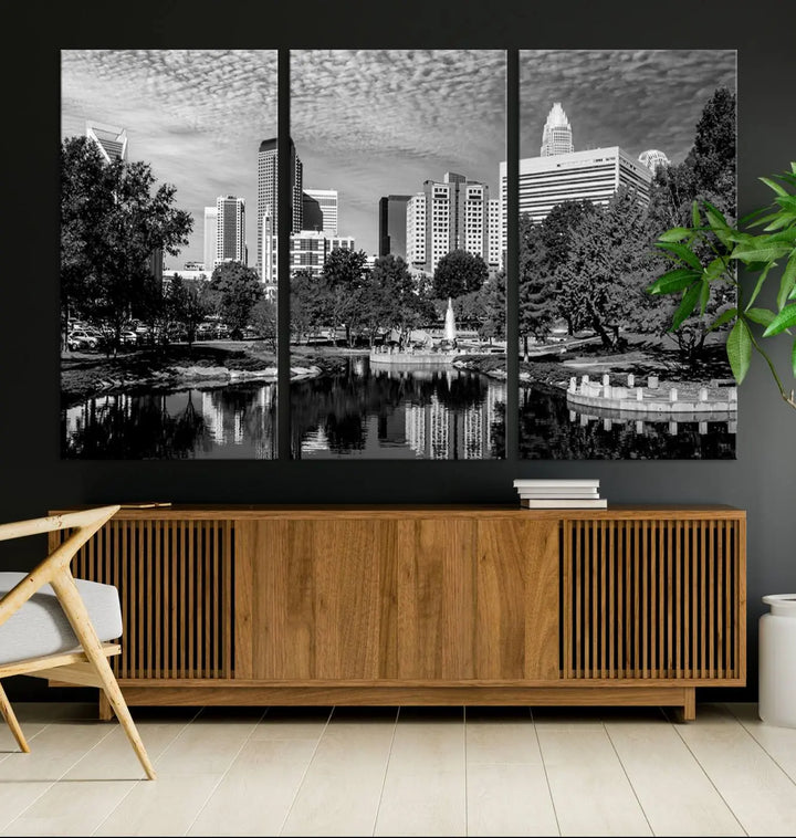 The living room features a captivating triptych titled "Charlotte City Cloudy Skyline Black and White Wall Art Cityscape Canvas Print," crafted on museum-quality canvas with UV-protective coating. Modern decor accentuates the dynamic scene.