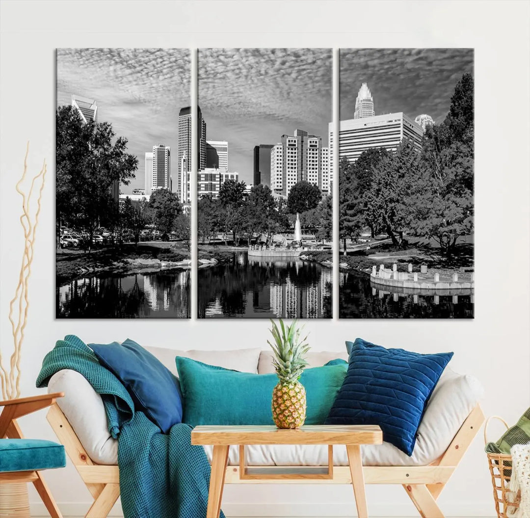 The living room features a captivating triptych titled "Charlotte City Cloudy Skyline Black and White Wall Art Cityscape Canvas Print," crafted on museum-quality canvas with UV-protective coating. Modern decor accentuates the dynamic scene.