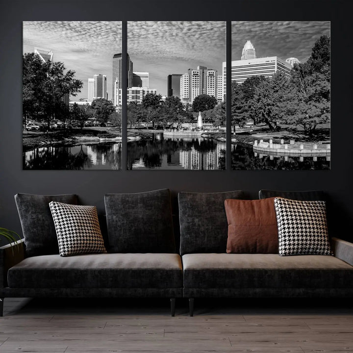 The living room features a captivating triptych titled "Charlotte City Cloudy Skyline Black and White Wall Art Cityscape Canvas Print," crafted on museum-quality canvas with UV-protective coating. Modern decor accentuates the dynamic scene.