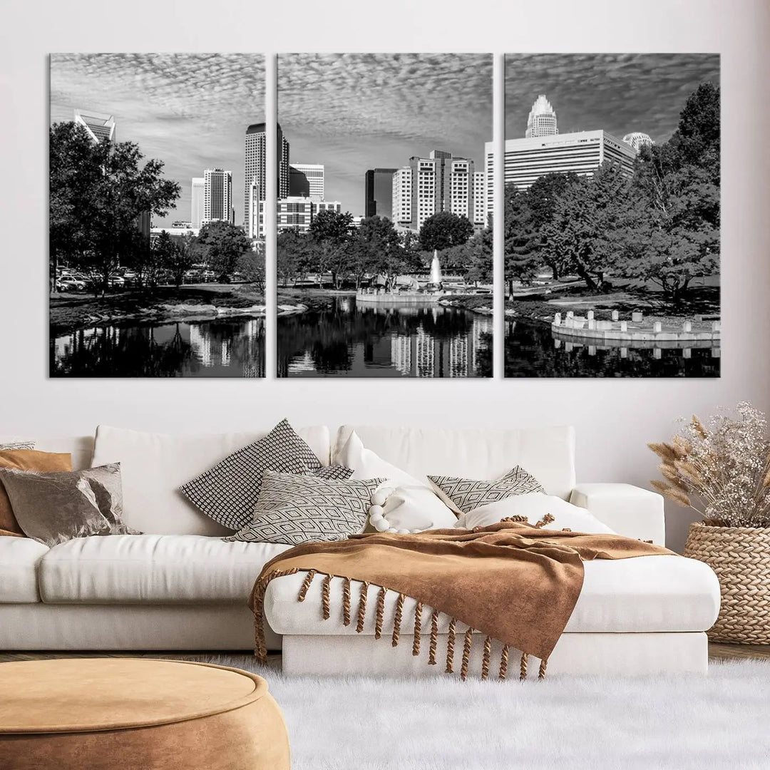 The living room features a captivating triptych titled "Charlotte City Cloudy Skyline Black and White Wall Art Cityscape Canvas Print," crafted on museum-quality canvas with UV-protective coating. Modern decor accentuates the dynamic scene.