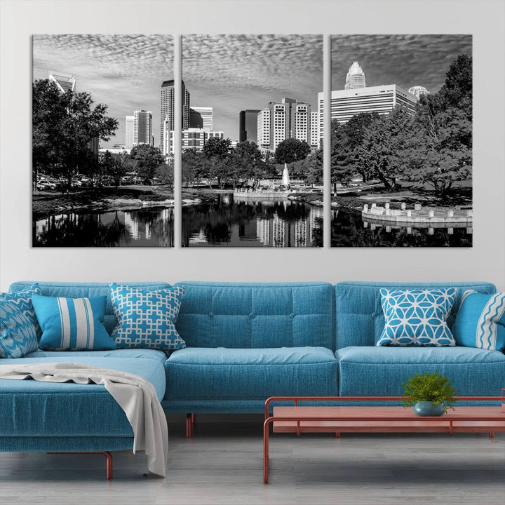 The living room features a captivating triptych titled "Charlotte City Cloudy Skyline Black and White Wall Art Cityscape Canvas Print," crafted on museum-quality canvas with UV-protective coating. Modern decor accentuates the dynamic scene.