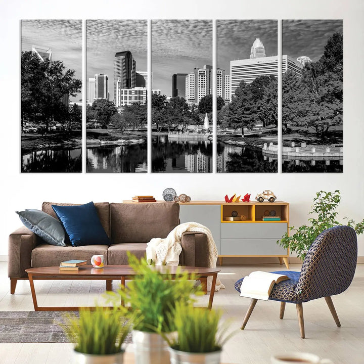 The living room features a captivating triptych titled "Charlotte City Cloudy Skyline Black and White Wall Art Cityscape Canvas Print," crafted on museum-quality canvas with UV-protective coating. Modern decor accentuates the dynamic scene.