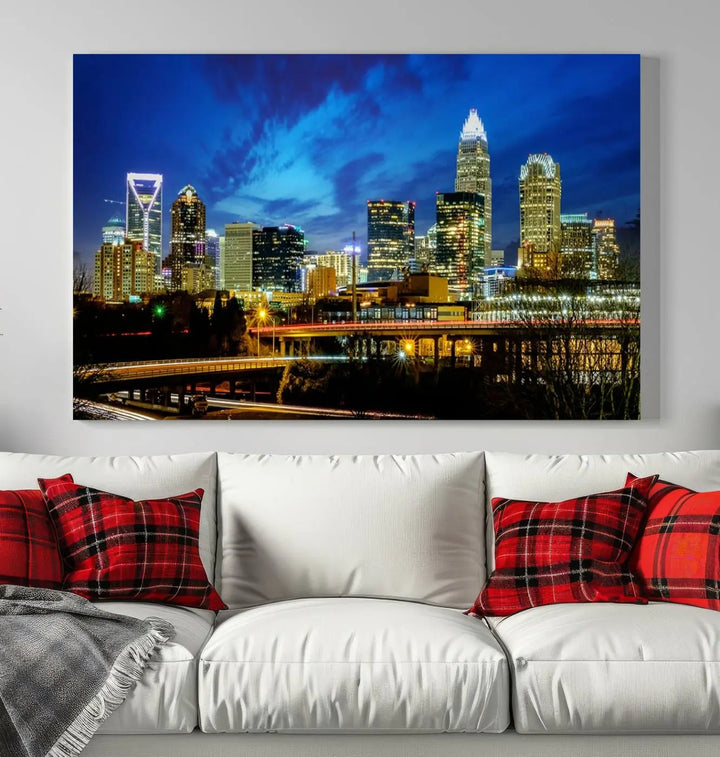 A modern living room highlighted by the "Charlotte City Lights Cloudy Blue Night Skyline Cityscape View" wall art canvas print, crafted on museum-quality canvas with UV-protective coating.