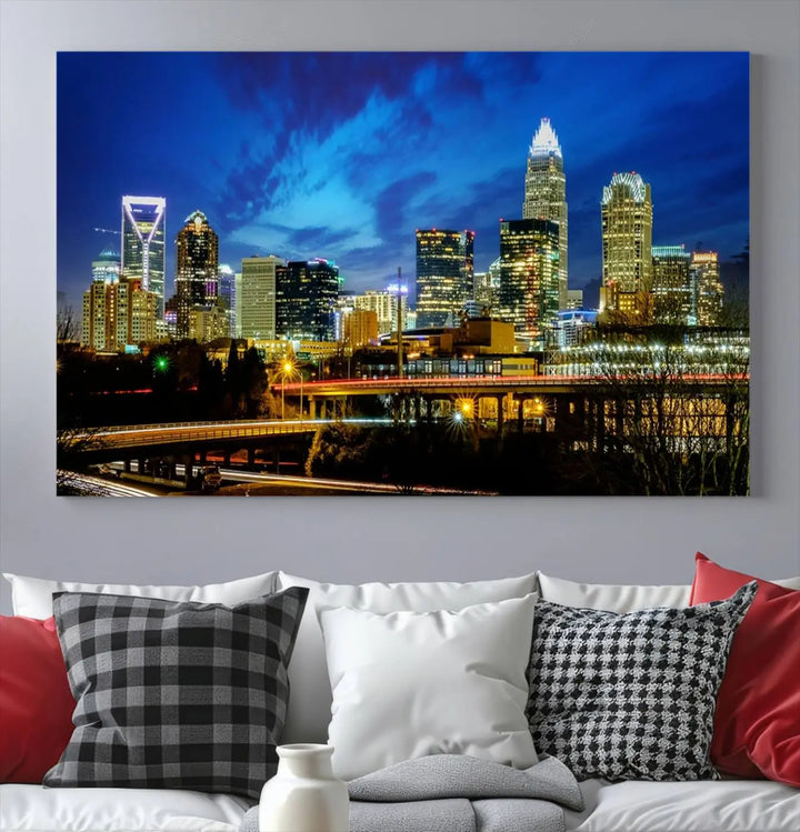 A modern living room highlighted by the "Charlotte City Lights Cloudy Blue Night Skyline Cityscape View" wall art canvas print, crafted on museum-quality canvas with UV-protective coating.