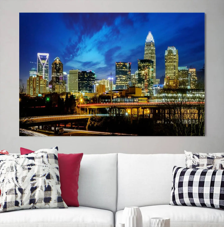 A modern living room highlighted by the "Charlotte City Lights Cloudy Blue Night Skyline Cityscape View" wall art canvas print, crafted on museum-quality canvas with UV-protective coating.