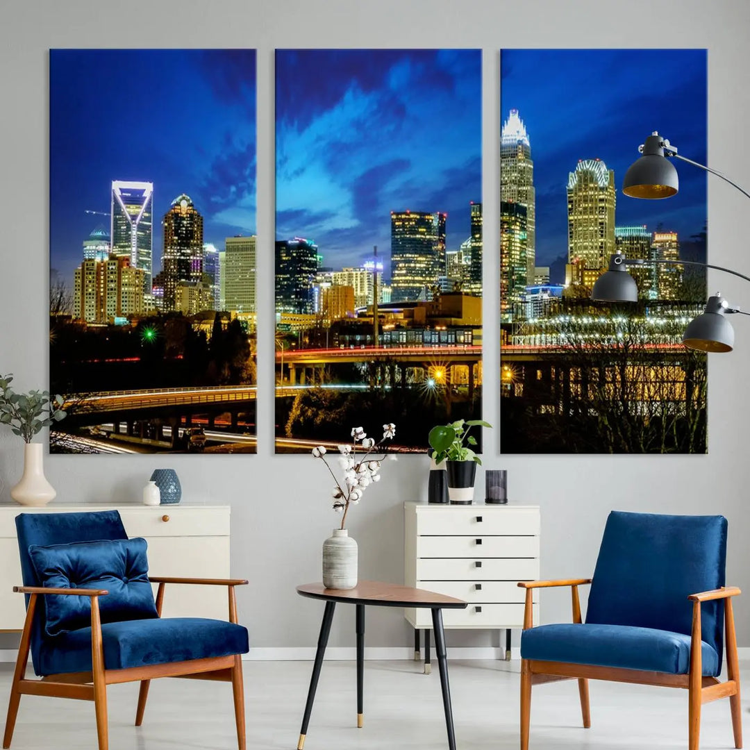 A modern living room highlighted by the "Charlotte City Lights Cloudy Blue Night Skyline Cityscape View" wall art canvas print, crafted on museum-quality canvas with UV-protective coating.