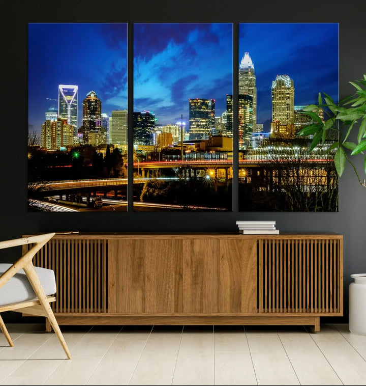 A modern living room highlighted by the "Charlotte City Lights Cloudy Blue Night Skyline Cityscape View" wall art canvas print, crafted on museum-quality canvas with UV-protective coating.